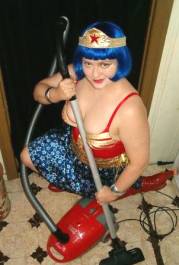 Evelyn Hartogh as Wonder Woman preparing to vacuum (Alicia Lane 2006)